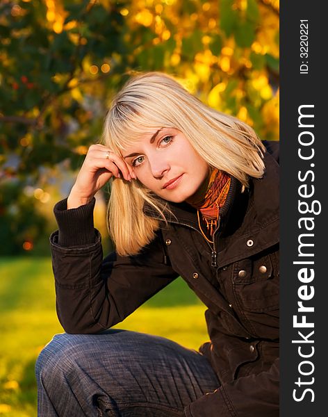 Beautiful blond girl on autumn background