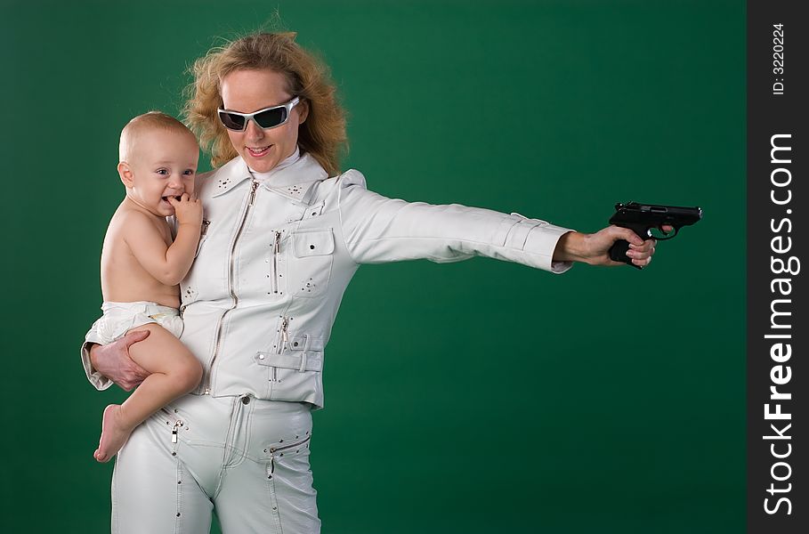 Woman with gun holds her son. Woman with gun holds her son