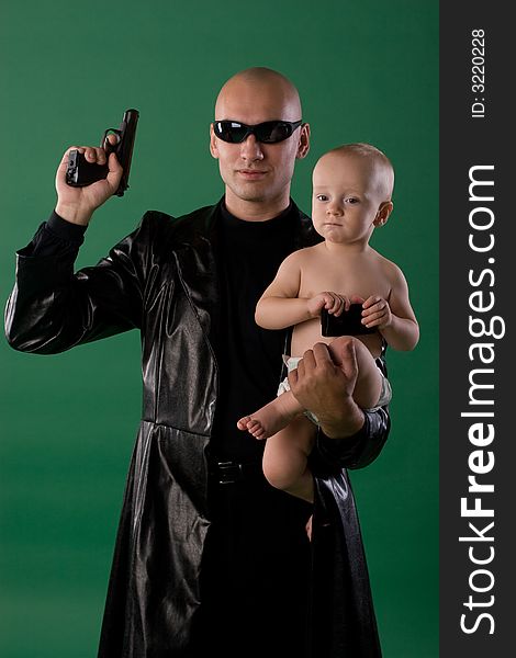 Man with gun holds his son. Man with gun holds his son