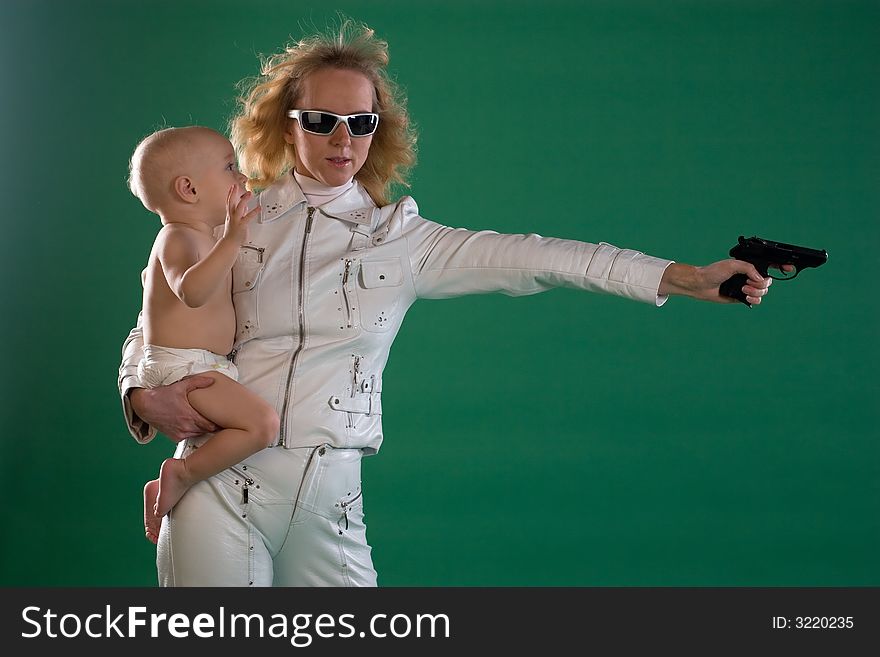 Woman with gun holds her son. Woman with gun holds her son