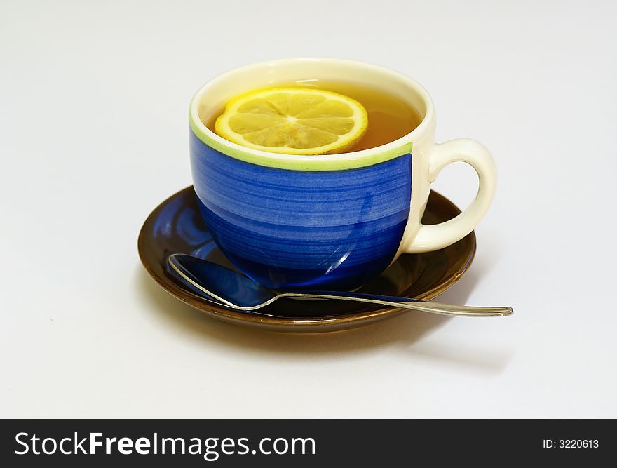 Cup of tea with lemon, white background