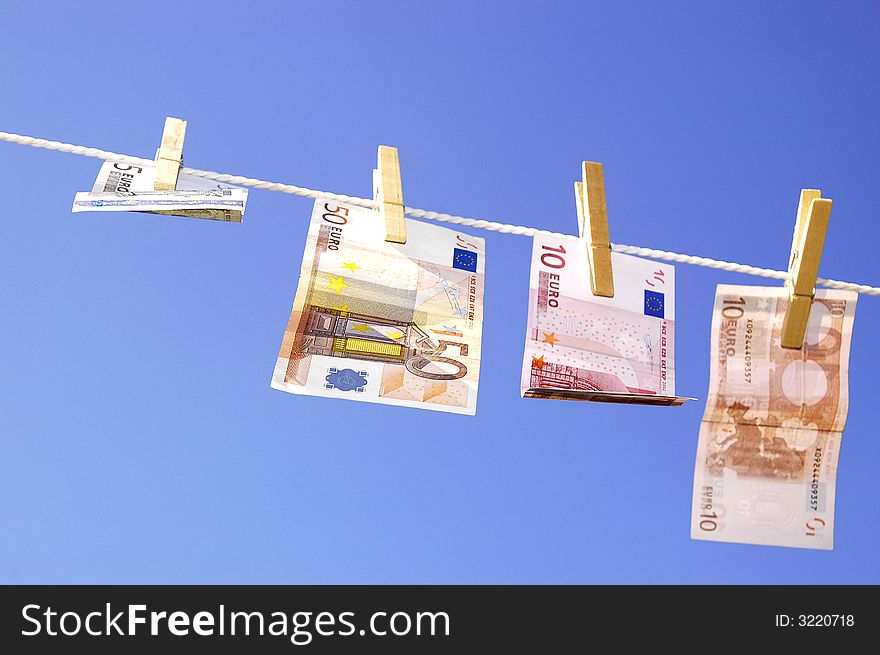 Photo of money hanging on the clothesline on the blue sky. Photo of money hanging on the clothesline on the blue sky