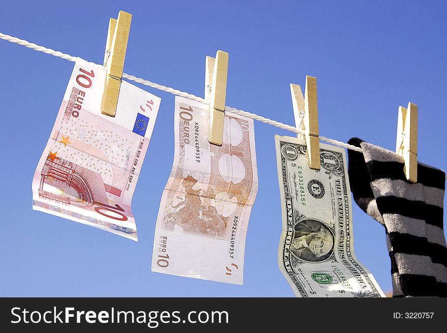 Photo of money and sock hanging on the clothesline on the blue sky. Photo of money and sock hanging on the clothesline on the blue sky