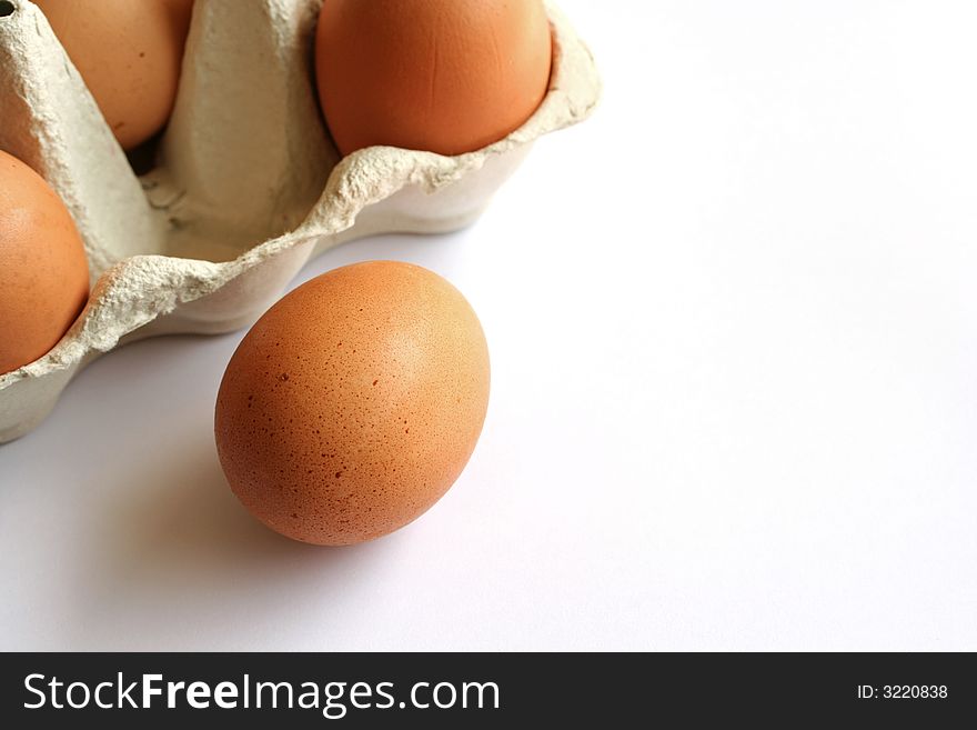 A carton of brown eggs with copyspace