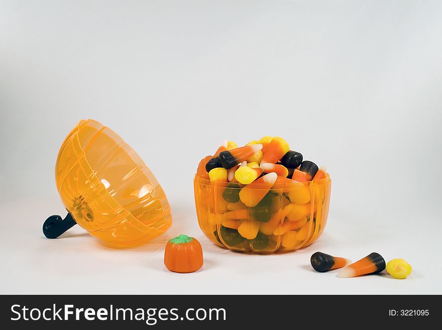Halloween candy in a pumpkin shaped jar. Halloween candy in a pumpkin shaped jar.