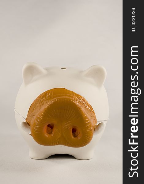 White piggy bank wearing a boar's nose. White piggy bank wearing a boar's nose.