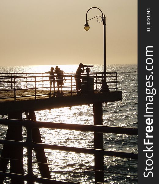 People on LA pier at sunset