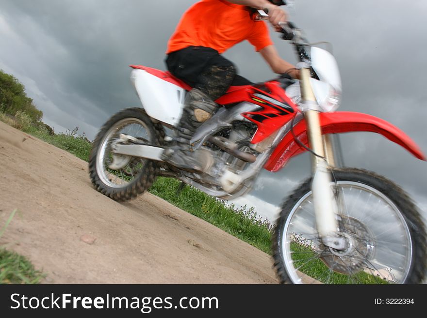 Moving bike in a close-up view against dark cloudy skies