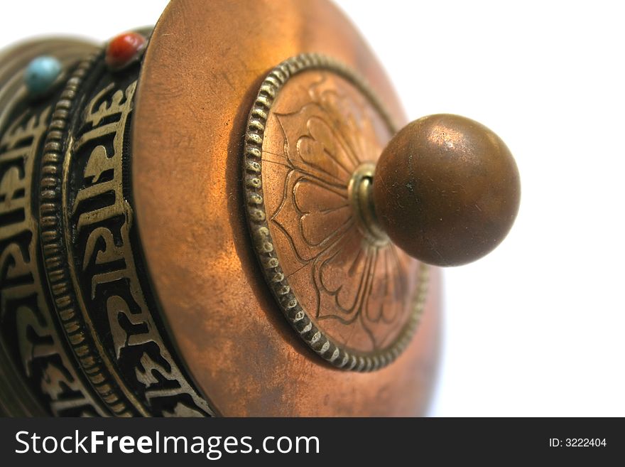Close-up of tibetan portable prayer mill isolated on a white background