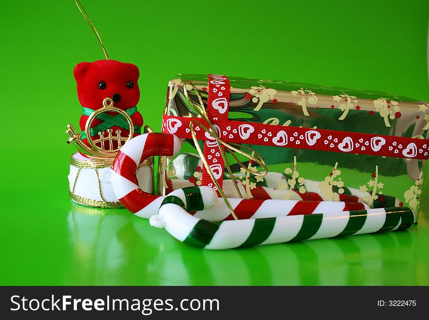 Christmas decorations on a green background with a wrapped present