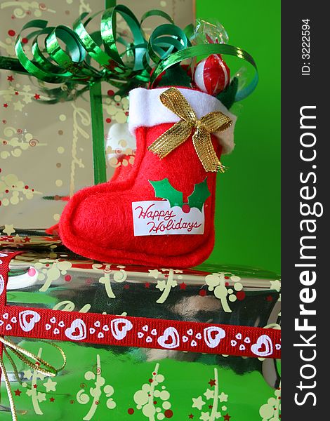Miniature Christmas Stocking on a gold wrapped gift. Miniature Christmas Stocking on a gold wrapped gift
