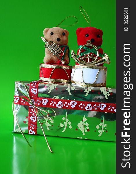 Two bears on a christmas gift, red teddy infront