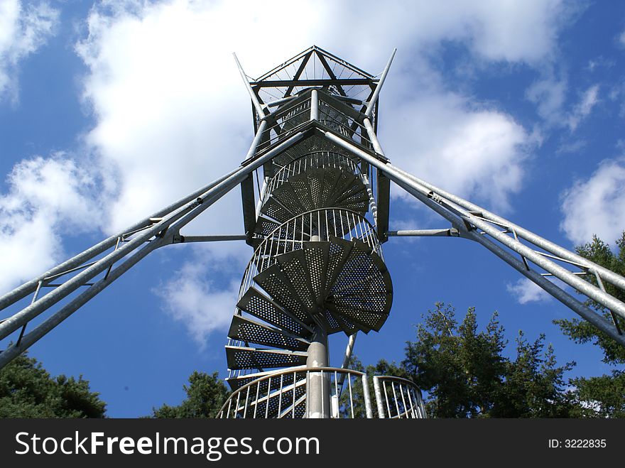 Metal winding staircase against a blue sky. Metal winding staircase against a blue sky.