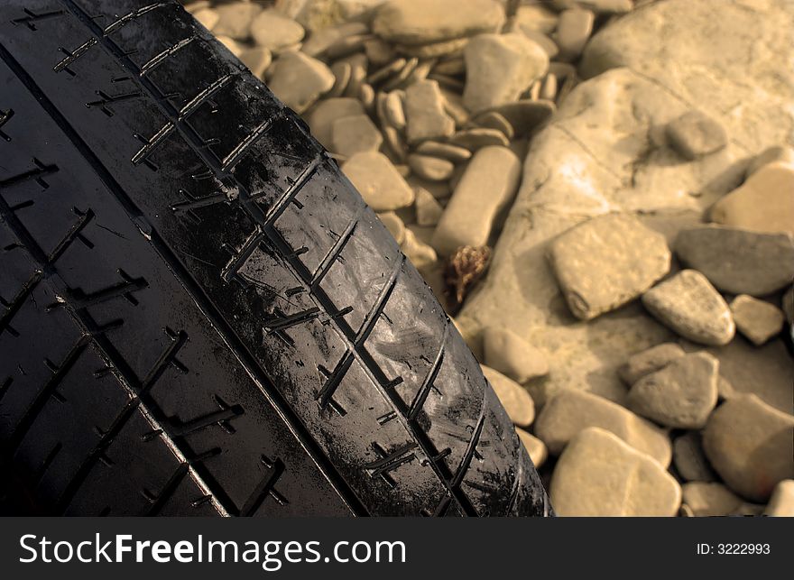 Old tyre on rocks looking down at it. Old tyre on rocks looking down at it