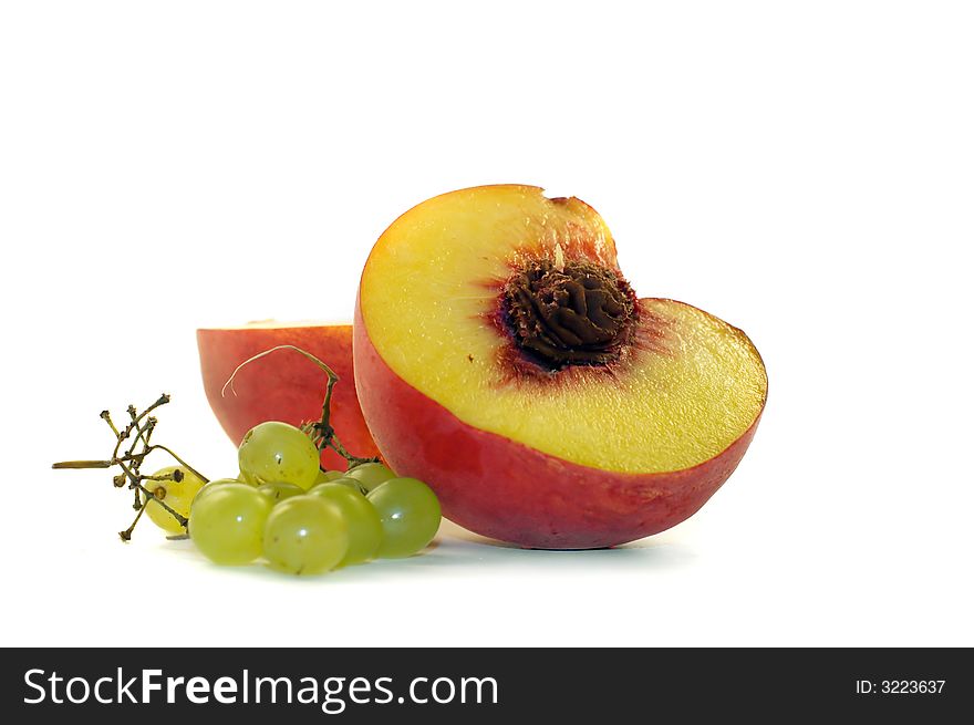 Bunch of grapes and two slices of peach. Bunch of grapes and two slices of peach