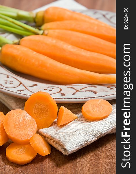 Fresh carrots on the grey plate