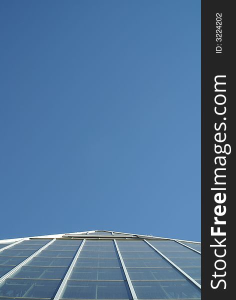 Top of glass pyramid against a blue sky. Top of glass pyramid against a blue sky