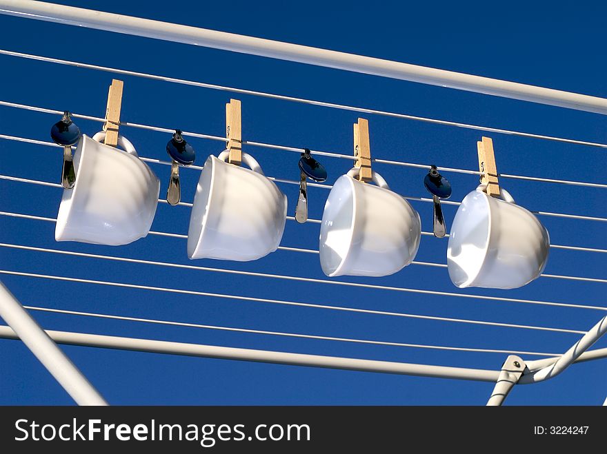 Spoons and cups on the clothes horse. Spoons and cups on the clothes horse