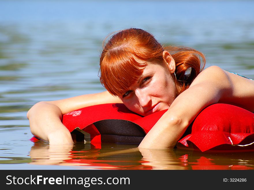 The girl floats on an inflatable mattress. The girl floats on an inflatable mattress