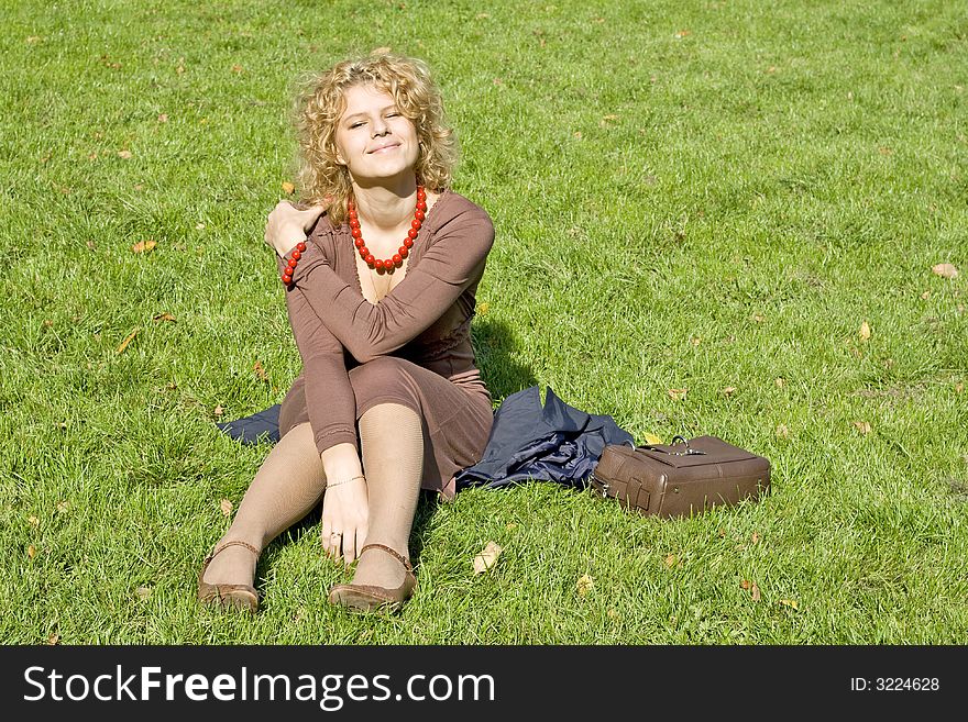 Caucasian women sits on grass
