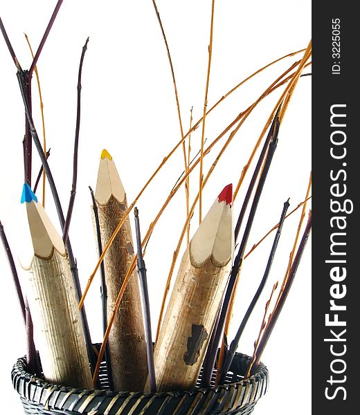 Composition of school and office articles: coloured pencils in basket on white background