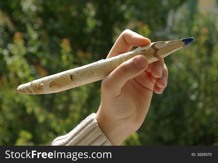 Child`s hand holding a pencil. Child`s hand holding a pencil