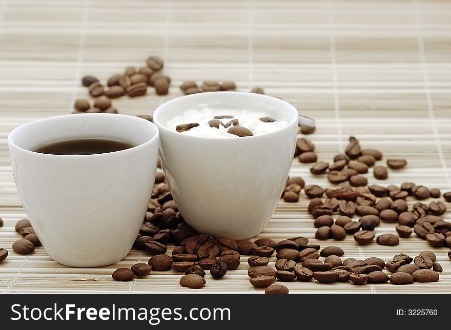 Cups of coffee with beans