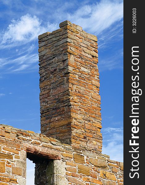 Ruined chimney in Orkney sandstone against blue sky