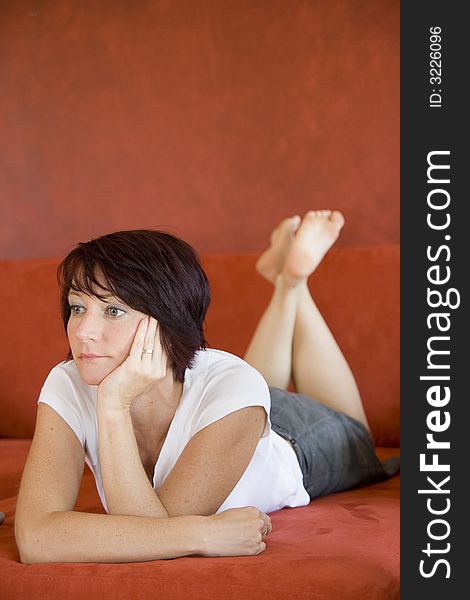 Young girl on a sofa in living room. Young girl on a sofa in living room.