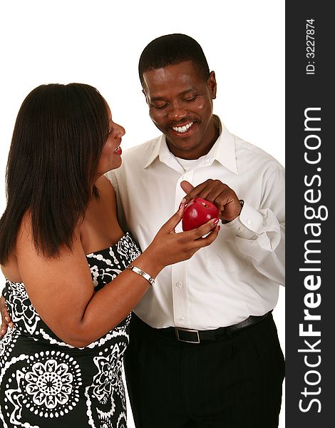 African american couple posing as adam and eve. adam touching the apple from eve. African american couple posing as adam and eve. adam touching the apple from eve