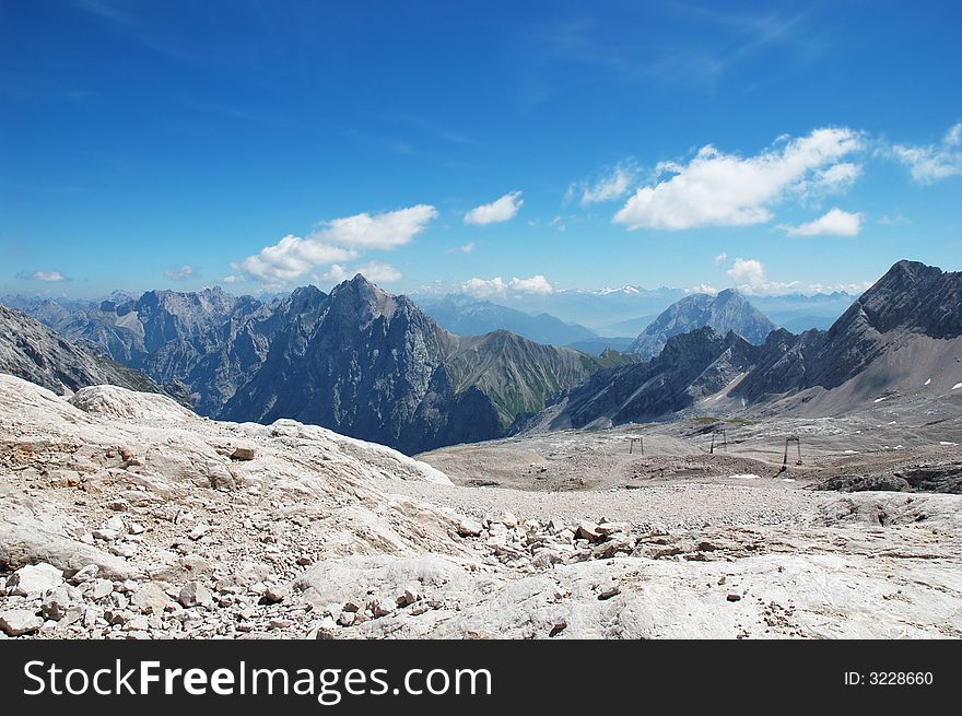 Beautiful view of the alps on a warm day with blue sky and white clouds