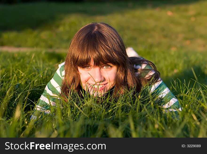 Pretty girl is stolen on a dense green grass. Pretty girl is stolen on a dense green grass