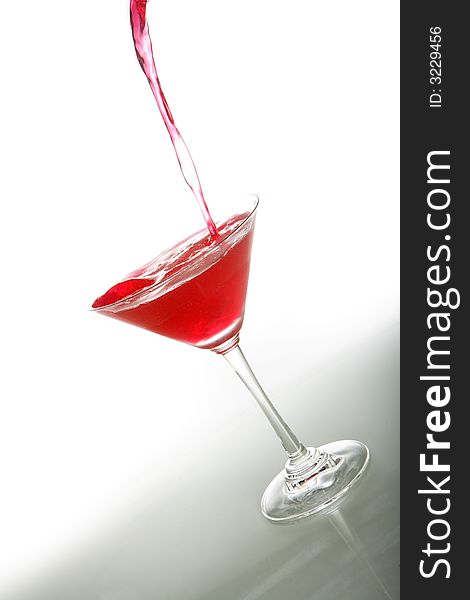 A photo of martini glass with red cocktail and ice. A photo of martini glass with red cocktail and ice