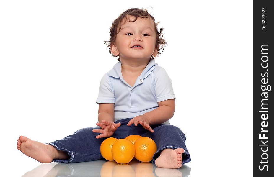 The child playing with oranges. The child playing with oranges.