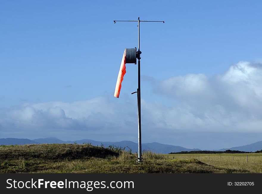 Airport windsock on a pole, show no wind.