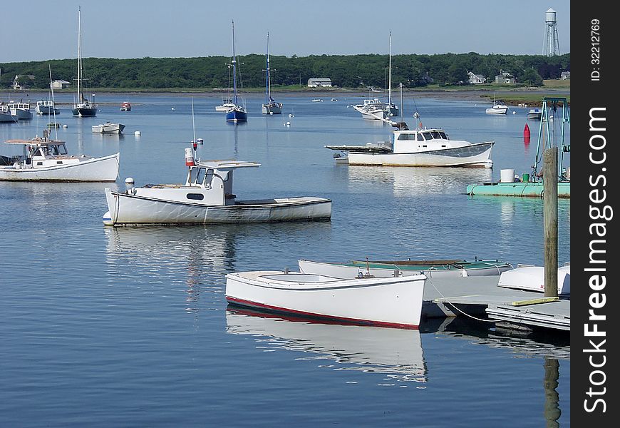 Maine lobster boats in harbor on clear summer day. Maine lobster boats in harbor on clear summer day.