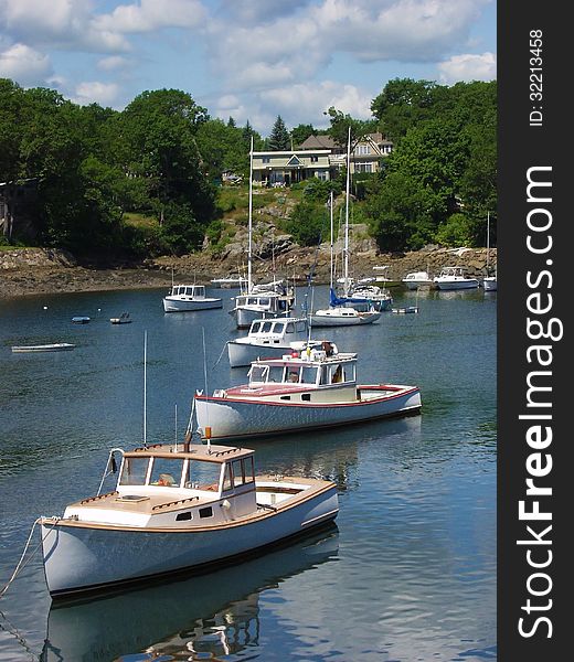 Maine lobster boats in harbor on clear summer day in the village of Cape Porpoise, Maine. Maine lobster boats in harbor on clear summer day in the village of Cape Porpoise, Maine.