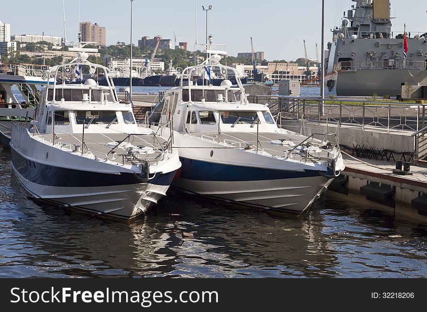 The boat at the mooring costs waiting for passengers in the light of a bright sun