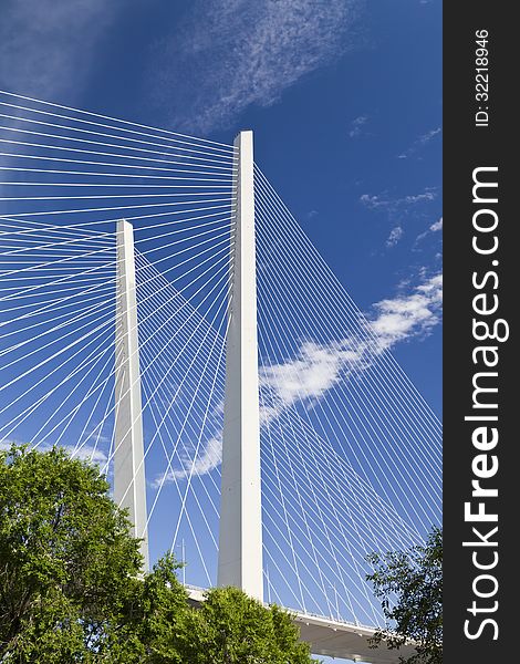 The big suspension bridge against the blue sky leaves up