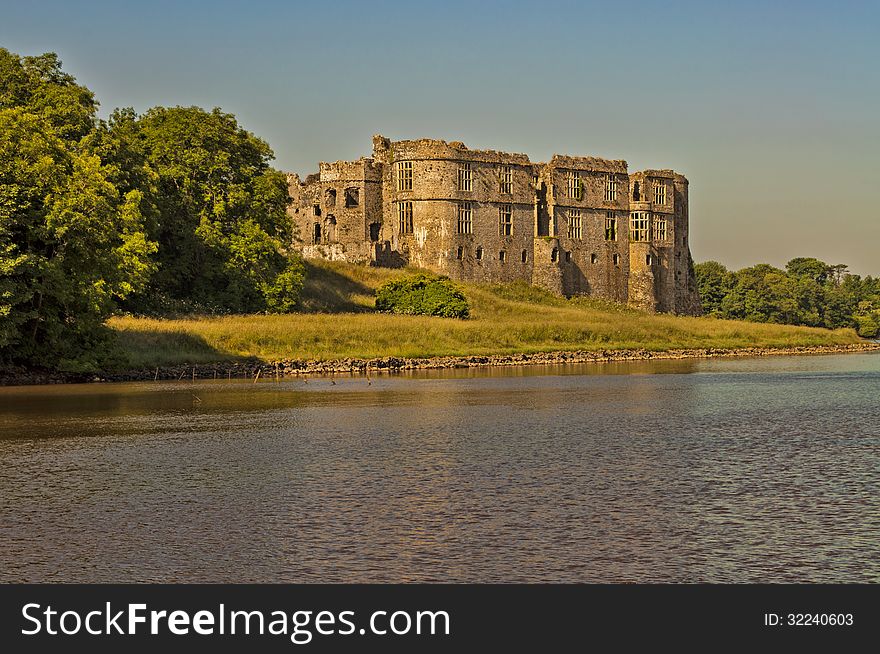 Image of carew castle taken early evening from across the lake. Image of carew castle taken early evening from across the lake
