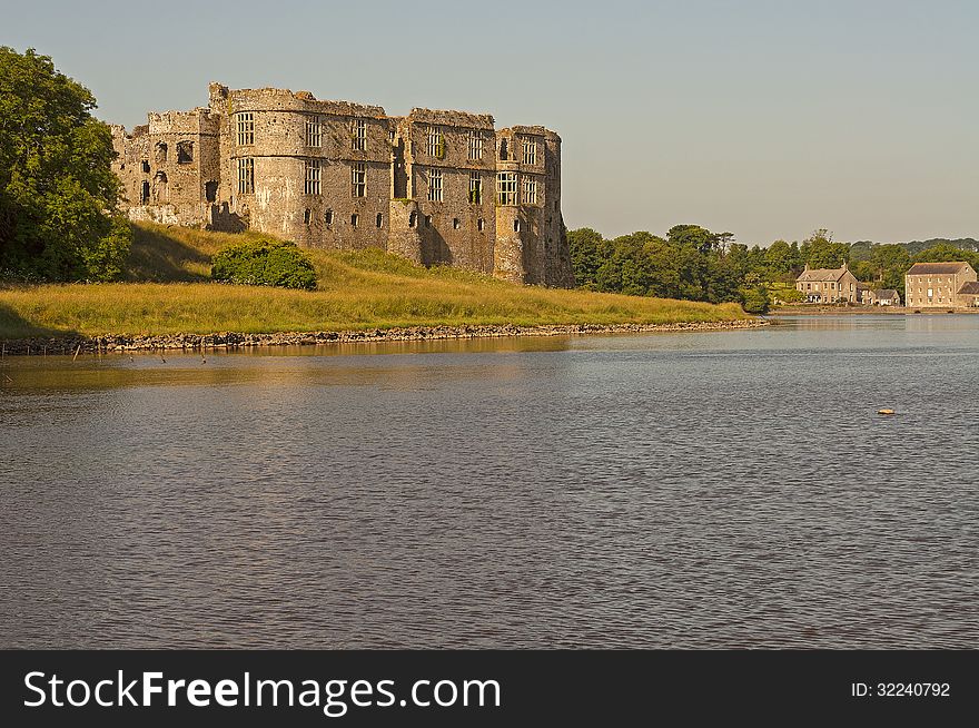 Image of carew castle taken early evening from across the lake. Image of carew castle taken early evening from across the lake