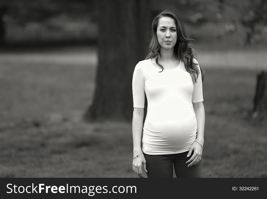 Pregnant woman standing in the park