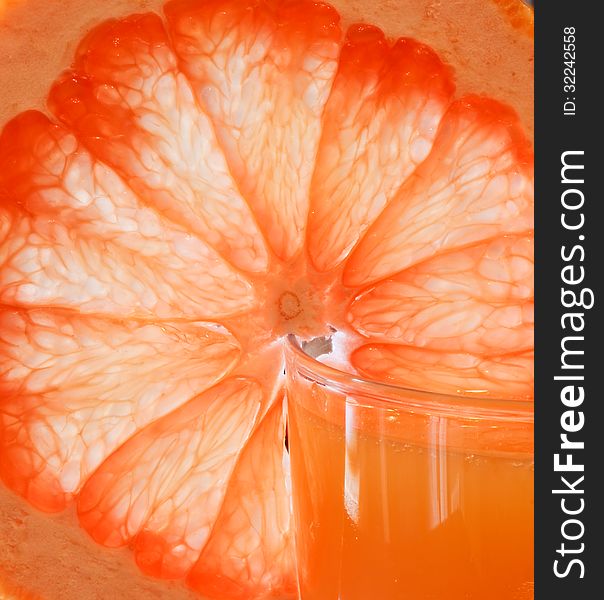 Glass of grapefruit juice with a slice of grapefruit