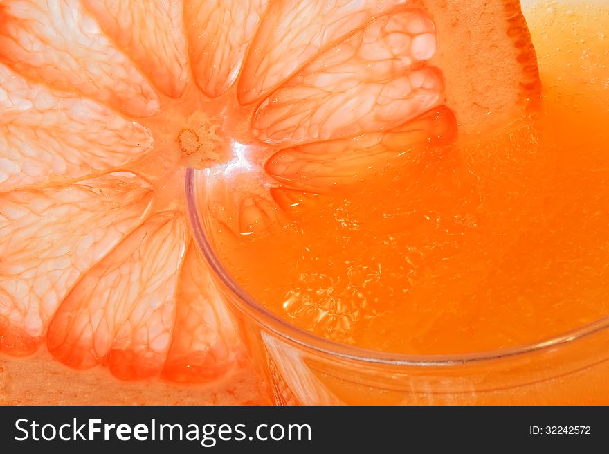 Glass of grapefruit juice with a slice of grapefruit