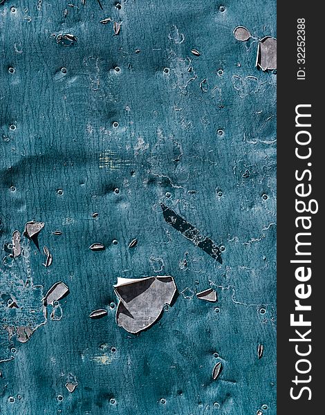 Blue peeling paint on a metal door abstract background. Blue peeling paint on a metal door abstract background