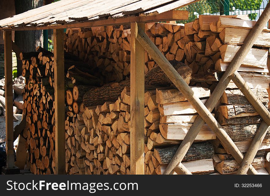 Stack of wood under cover on summer day