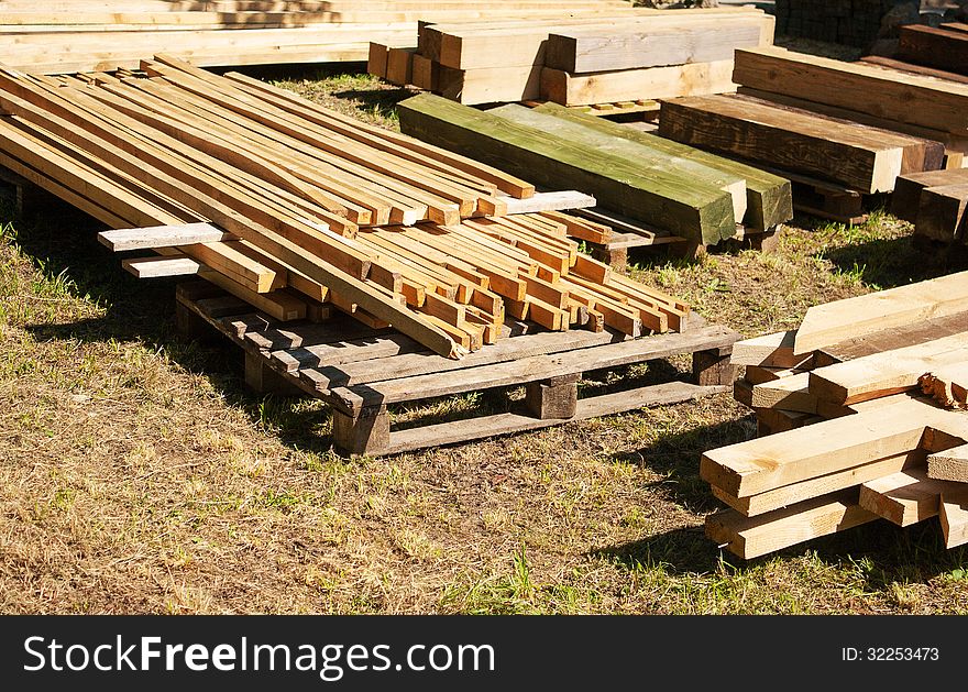 Wood planks for construction outside on summer day
