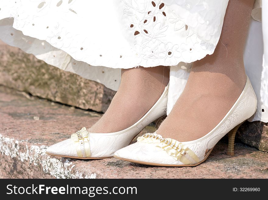 The bride's wedding shoes and part of the skirt. The bride's wedding shoes and part of the skirt