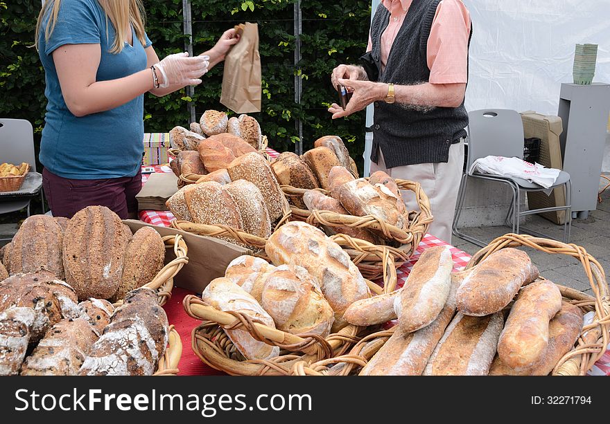 Sale of organic loaves at outdoor farmers market. Sale of organic loaves at outdoor farmers market