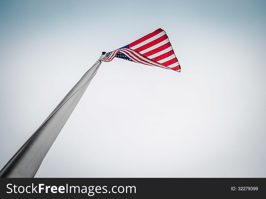 Looking up at a US flag flying. Looking up at a US flag flying